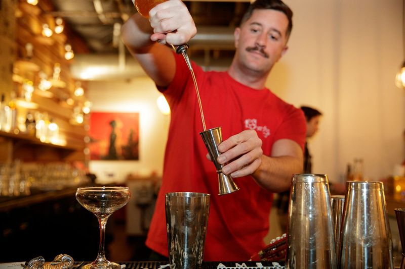 Rooster and the Pig bartender Colin Havens mixes The Raven, a specialty cocktail in Palm Springs, Calif., on November 13, 2024.