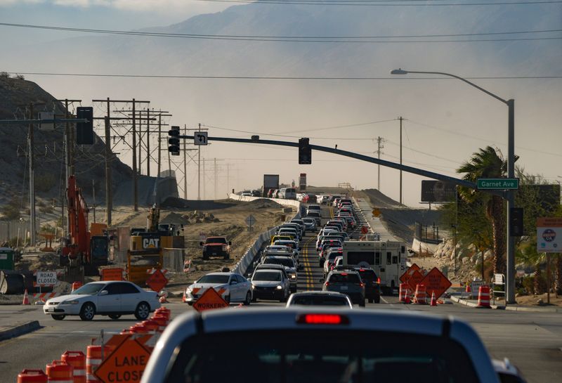 Commuters navigate high winds and blowing sand along Indian Canyon Dr. south of Garnet Ave. in North Palm Springs, Calif., Feb. 11, 2025.