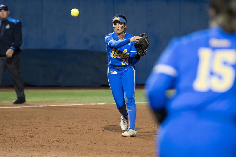 Jun 2, 2024; Oklahoma City, OK, USA; UCLA Bruins utility Thessa Malau'ulu (24) throws to infielder Jordan Woolery (15) for an out in the fourth inning against the Stanford Cardinals during a Women's College World Series softball losers bracket elimination game at Devon Park. Mandatory Credit: Brett Rojo-USA TODAY Sports