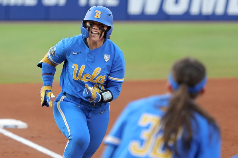 UCLA's Megan Grant (43) celebrates after hitting a home run in the second inning of a Women's College World Series softball game between the Stanford Cardinal and the UCLA Bruins at Devon Park in Oklahoma City, Sunday, June 2, 2024. Stanford won 3-1.