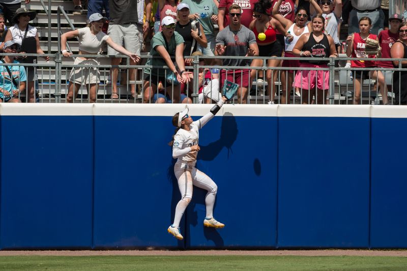 Jun 1, 2024; Oklahoma City, OK, USA; UCLA Bruins outfielder Janelle Meono (3) makes a catch at the wall against the Oklahoma Sooners in the third inning during a Women's College World Series softball winners bracket game at Devon Park. Mandatory Credit: Brett Rojo-USA TODAY Sports