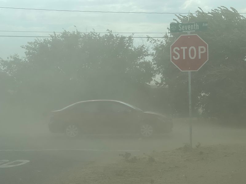 A vehicle in Hesperia drives through a dust storm brought on by heavy winds. Spring’s roller coaster ride of weather continues as rain, cold temperatures and windy conditions are expected in the High Desert.