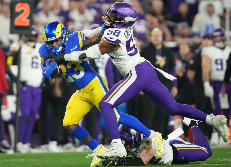 Los Angeles Rams running back Kyren Williams (23) is tackled by Minnesota Vikings linebacker Jonathan Greenard (58) during their playoff game at State Farm Stadium on Jan. 13, 2025, in Glendale.