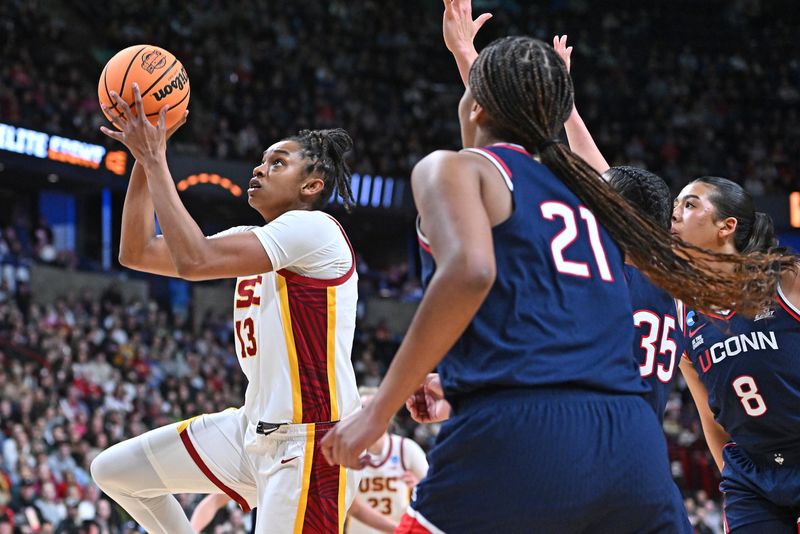 Mar 31, 2025; Spokane, WA, USA; USC Trojans center Rayah Marshall (13) shoots against UConn Huskies guard Azzi Fudd (35) during the first half of a Elite 8 NCAA Tournament basketball game at Spokane Arena. Mandatory Credit: James Snook-Imagn Images