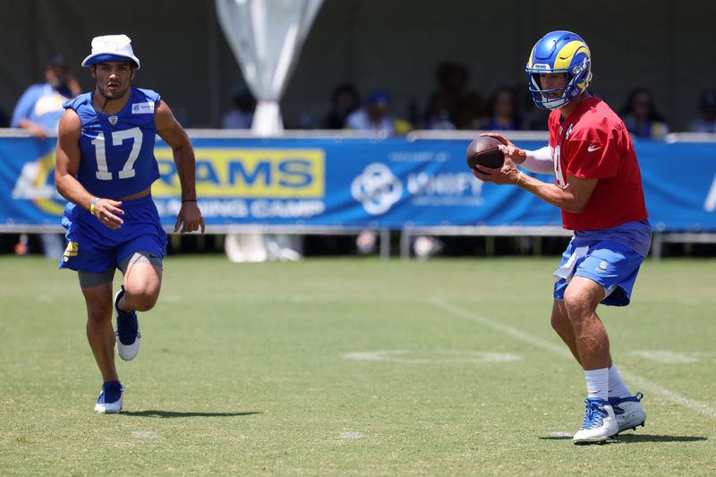 Jul 31, 2024; Los Angeles, CA, USA; Los Angeles Rams wide receiver Puka Nacua (17) and quarterback Matthew Stafford (9) participate in jog through during training camp at Loyola Marymount University. Mandatory Credit: Kiyoshi Mio-USA TODAY Sports