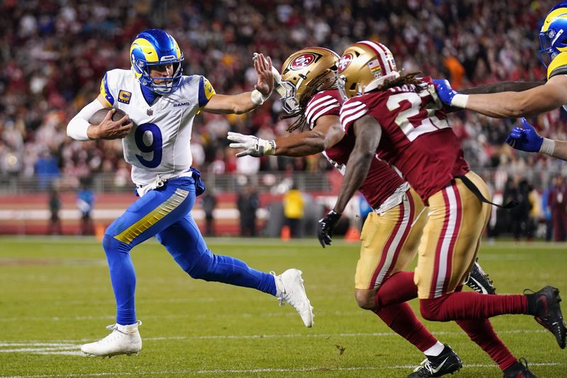Dec 12, 2024; Santa Clara, California, USA; Los Angeles Rams quarterback Matthew Stafford (9) runs with the ball as San Francisco 49ers linebacker Fred Warner (54) defends in the fourth quarter at Levi's Stadium. Mandatory Credit: Cary Edmondson-Imagn Images