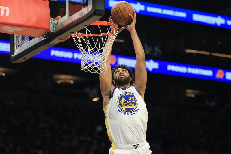 Apr 8, 2025; Phoenix, Arizona, USA; Golden State Warriors forward Trayce Jackson-Davis (32) dunks the ball against the Phoenix Suns during the first half at Footprint Center. Mandatory Credit: Mark J. Rebilas-Imagn Images