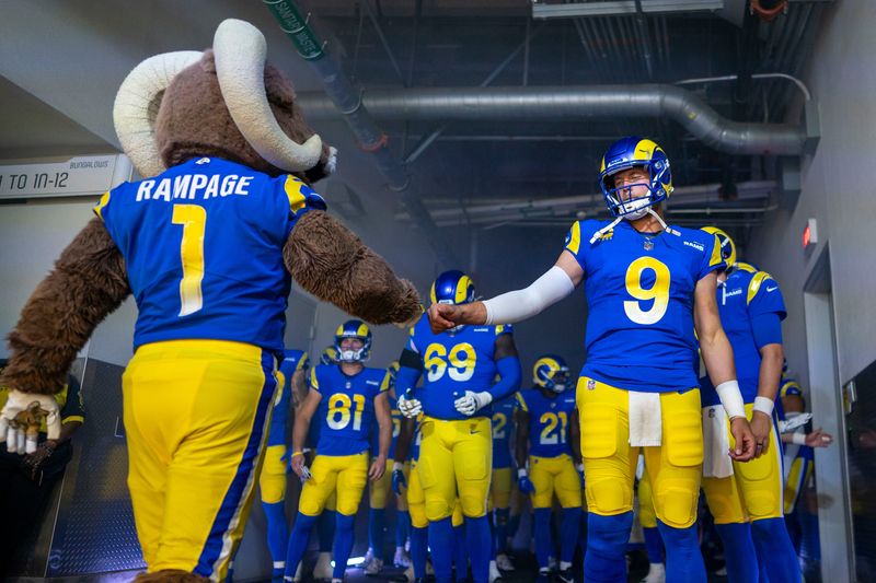 October 15, 2023; Inglewood, California, USA; Los Angeles Rams quarterback Matthew Stafford (9) fist bumps mascot Rampage in the tunnel before the game against the Arizona Cardinals at SoFi Stadium. Mandatory Credit: Kyle Terada-USA TODAY Sports