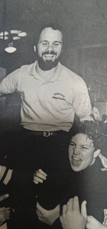 Ventura High School wrestling coach Paul Clementi is lifted on wrestler's shoulders in celebration.