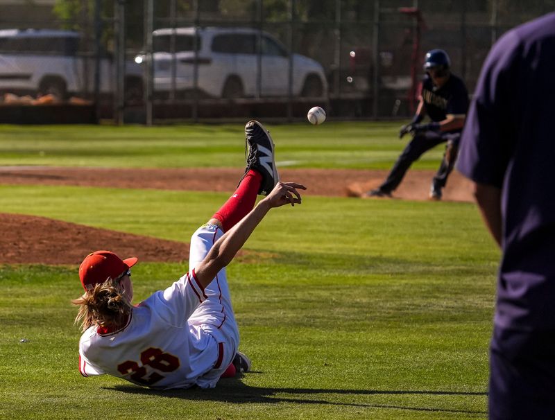 Palm Desert's Jake Brande throws to second base for a play as he falls on his back during their CIF-SS Division 2 opening-round playoff game in Palm Desert, Calif., Friday, May 16, 2025.