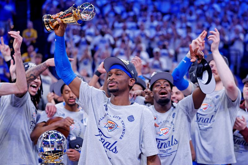 May 28, 2025; Oklahoma City, Oklahoma, USA; Oklahoma City Thunder guard Shai Gilgeous-Alexander (2) celebrates with Magic Johnson West Conference Finals MVP trophy after defeating the Minnesota Timberwolves in game five to win the western conference finals for the 2025 NBA Playoffs at Paycom Center. Mandatory Credit: Alonzo Adams-Imagn Images