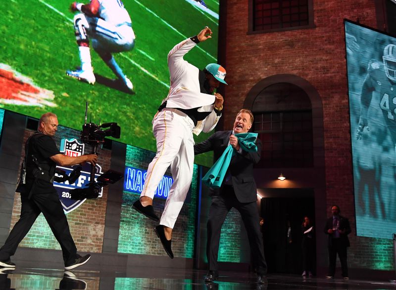 Clemson's Christian Wilkins crashes into NFL Commissioner Roger Goodell moments after the Dolphins made him the 13th overall pick in 2019.