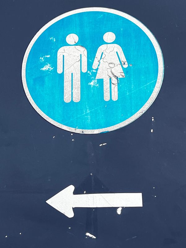A sign indicating public bathrooms in Newport.