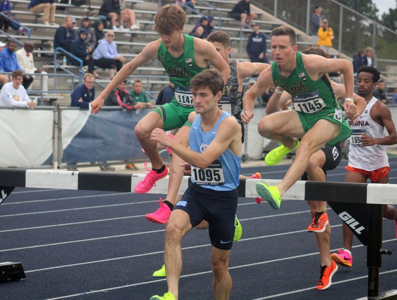 Marshall Williamson (1095) of North Carolina, C.J. Singleton (1147) of Notre Dame and Tom Seitzer (1145) of Notre Dame lead a pack over a jump in the men's 3,000-meter steeplechase  at the NCAA East Preliminary track and field championship at the University of North Florida in Jacksonville, Florida, on May 26, 2023. [Clayton Freeman/Florida Times-Union]