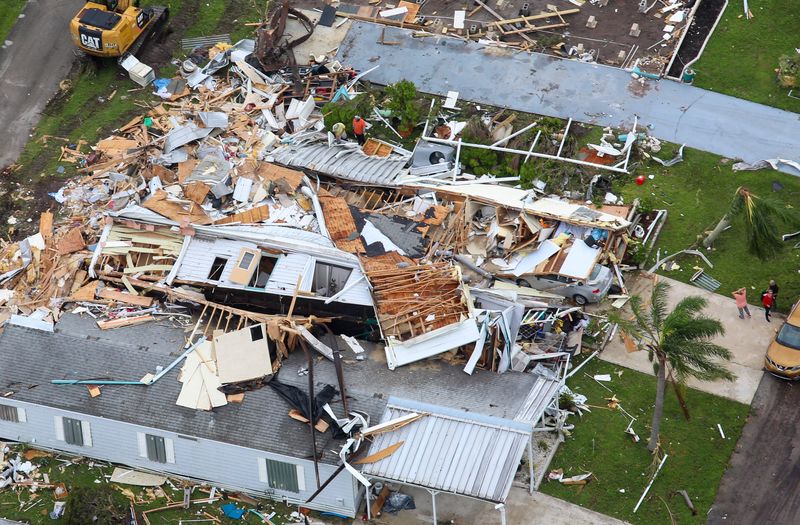 A person stands with their arms on their head while looking at damage to a home in Spanish Lakes Country Club Village, seen from an Indian River County Sheriff’s Office helicopter, Friday, Oct. 11, 2024, in St. Lucie County. At least six people died following suspected tornadoes Wednesday that ripped through the community in Lakewood Park near Fort Pierce and in other Treasure Coast areas.