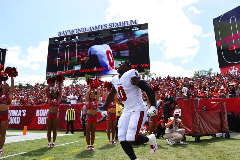 Sep 22, 2024; Tampa, Florida, USA; Tampa Bay Buccaneers linebacker Yaya Diaby (0) runs out of the tunnel as he is introduced before the game against the Denver Broncos at Raymond James Stadium. Mandatory Credit: Kim Klement Neitzel-Imagn Images