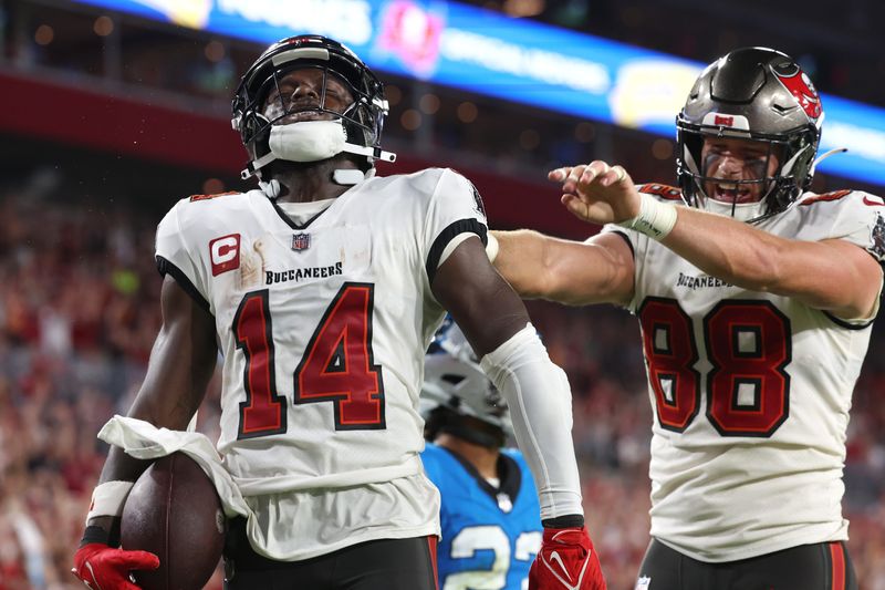 Dec 3, 2023; Tampa, Florida, USA; Tampa Bay Buccaneers wide receiver Chris Godwin (14) celebrates after he scored a touchdown against the Carolina Panthers during the second half at Raymond James Stadium. Mandatory Credit: Kim Klement Neitzel-USA TODAY Sports