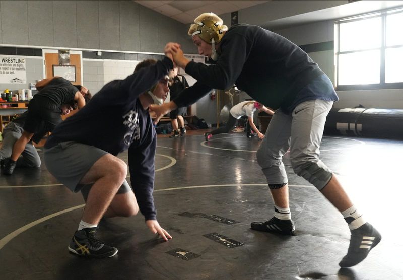 Mariner High School wrestler and 3-time state champion Maximus Brady, right, practices drills with teammate Clark Daley on Wednesday, February 19, 2025.