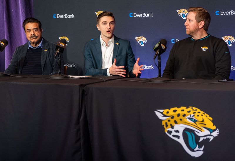 Jacksonville Jaguars Owner Shad Khan, left, listens as Jacksonville Jaguars General Manager James Gladstone, center, explained what he was bringing to the table during a press conference Monday morning February 24, 2025 at the Miller Electric Center in Jacksonville, Fla. as Head Coach Liam Coen, right, listened. [Doug Engle/Florida Times-Union]2025