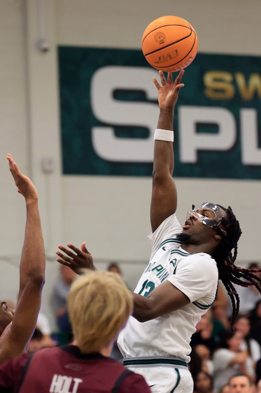 Jacksonville Dolphins guard Robert McCray V (13) drives the lane during the first half of the quarterfinal round of the ASUN men’s basketball tournament at Swisher Gymnasium Monday, March 2, 2025 in Jacksonville, Fla. [Corey Perrine/Florida Times-Union]
