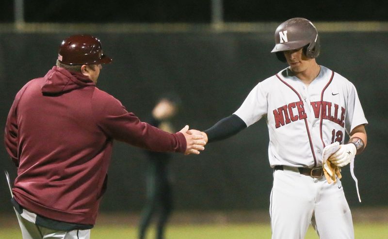 Nicevilles Matthew Marcantonio is congratulated by head coach Justin Bruce for his RBI hit at third during the Choctaw Niceville baseball game at Choctaw.