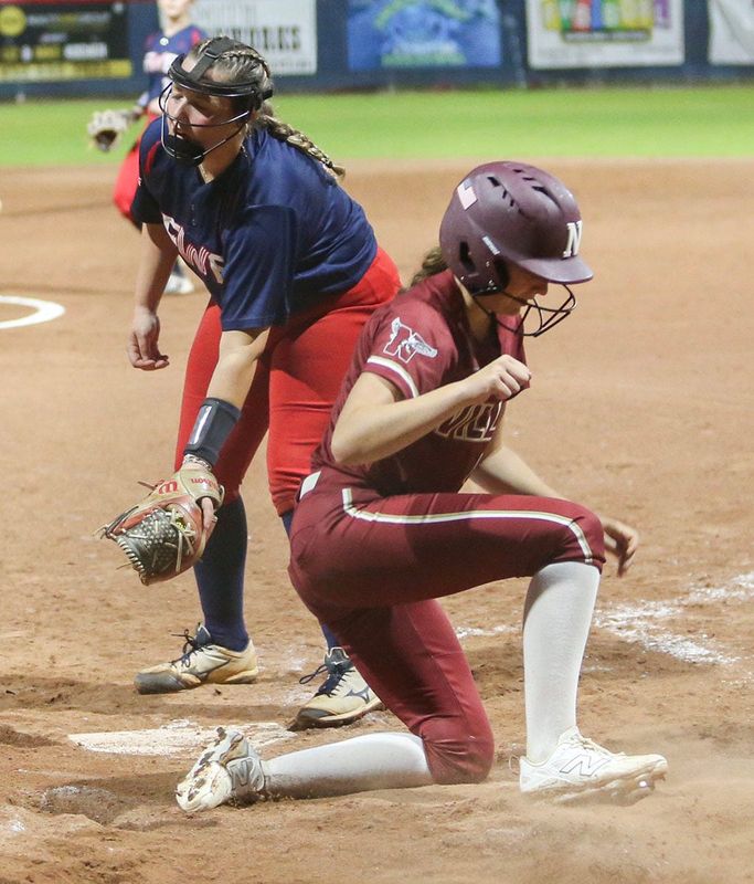 NicevilleÕs Anabelle Shackelford scores on a passed ball during the Fort Walton Beach Niceville softball game at FWB.