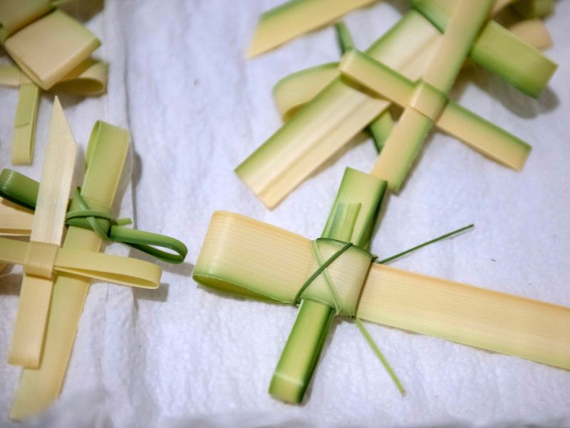 Bethesda-by-the-Sea flower guild members make hundreds of palm crosses in preparation for Palm Sunday services Friday March 22, 2024 in Palm Beach.
