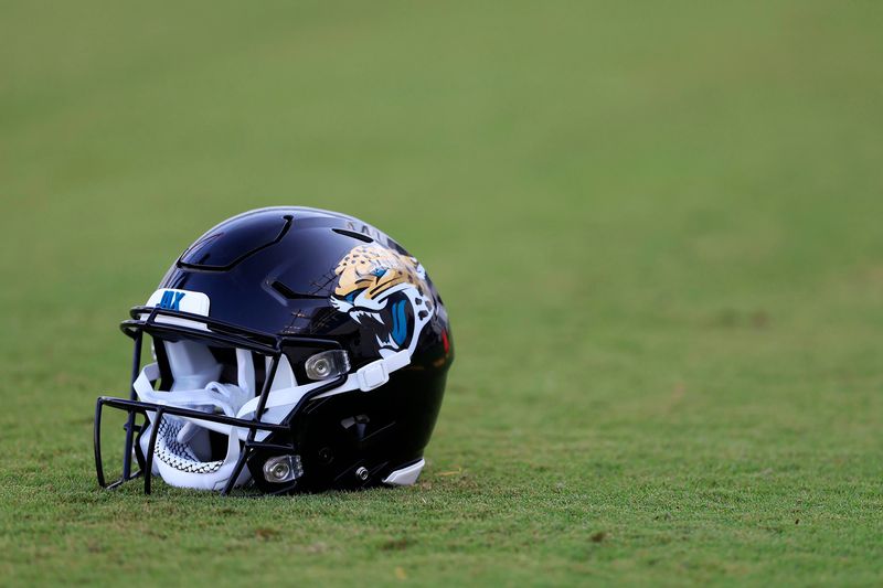 A Jacksonville Jaguars helmet lies on the turf Wednesday, July 26, 2023 at Miller Electric Center at EverBank Stadium in Jacksonville, Fla. Today marked the first day of training camp for the Jacksonville Jaguars.