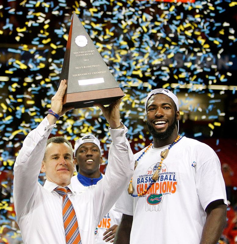 Florida Gators head coach Billy Donovan holds up the trophy next to Patric Young after defeating Kentucky 61-60 to win the 2014 SEC Tournament