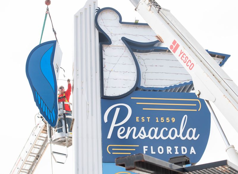 Jack Jensen, of Yesco Sign & Lighting Service, works on installing the new welcome to Pensacola sign between Bayfront Parkway and East Gregory Street near the Pensacola Bay Bridge in Pensacola on Wednesday, April 2, 2025.