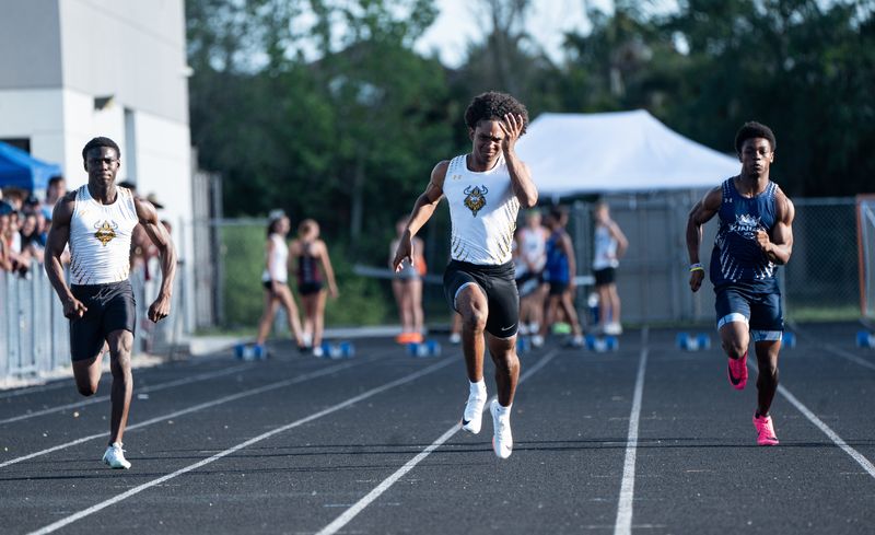 Bishop Verot’s Jyden German leads the 100 meters during the Private 8 Championship at First Baptist Academy in Naples on Friday, April 4, 2025. He would go on to win.