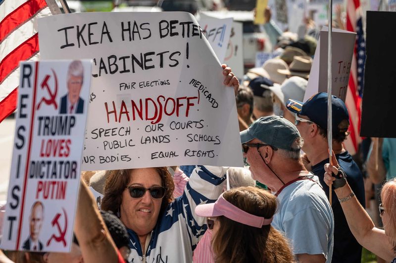 More than one thousand people lined the north and south side of PGA Boulevard near Kew Gardens Avenue with handmade signs as part of the national Hands Off! protests in Palm Beach Gardens, Fla., on April 5, 2025.