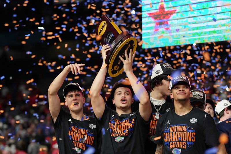 Apr 7, 2025; San Antonio, TX, USA; Florida Gators guard Walter Clayton Jr. (1) holds up the trophy after winning the national championship game of the Final Four of the 2025 NCAA Tournament at the Alamodome. Mandatory Credit: Bob Donnan-Imagn Images