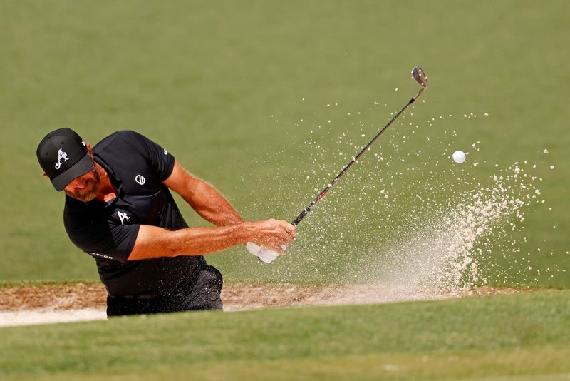 Dustin Johnson plays from the bunker on the second fairway during the first round of the Masters Tournament in Augusta, Georgia, on April 10, 2025.