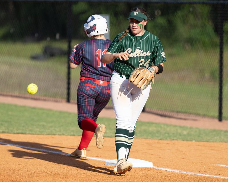 Taylor Lacey Price (11) can’t beat the throw to first past Trinity Catholic Liliana Ornelas (24) during the 2025 2A District 6 FHSAA Softball District Tournaments at Trinity Catholic High School in Ocala, FL on Wednesday, April 30, 2025. Trinity won 10-0 [Alan Youngblood/Ocala Star-Banner]