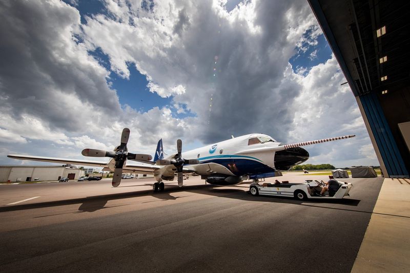 The NOAA hurricane hunter P3 Orion aircraft nicknamed Kermit is towed back into their hangar after engine testing at NOAA's Aircraft Operations Center at Lakeland Linder Airport in Lakeland Fl.