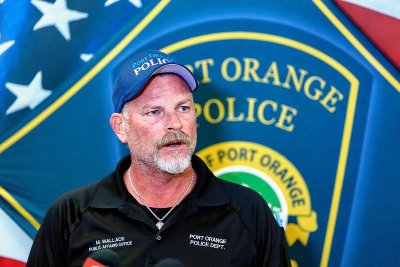 Port Orange Police Public Information Officer Mike Wallace addresses the media during a press conference after a man shot two people and himself at the Walgreens on Taylor Road, May 7, 2025.