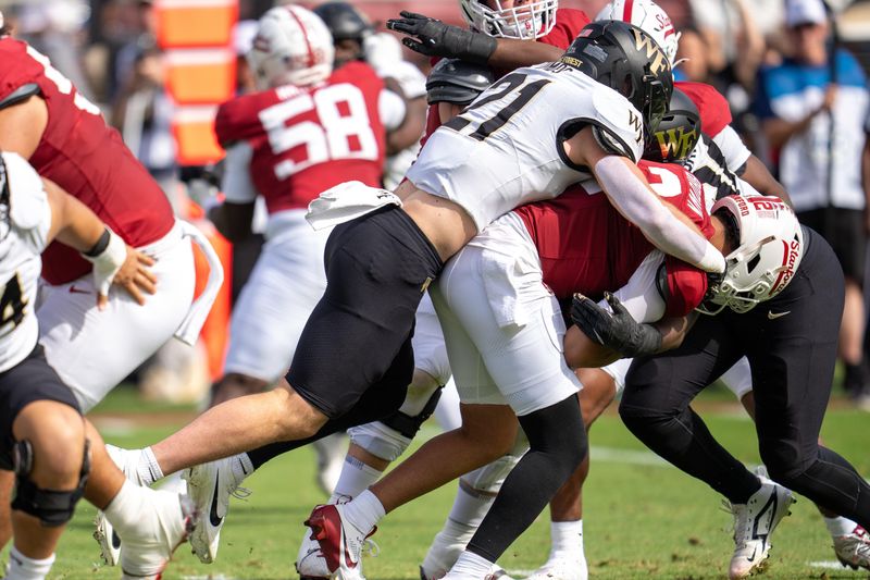 Oct 26, 2024; Stanford, California, USA; Wake Forest Demon Deacons linebacker Branson Combs (21) sacks Stanford Cardinal quarterback Elijah Brown (2) during the first quarter at Stanford Stadium. Mandatory Credit: Neville E. Guard-Imagn Images