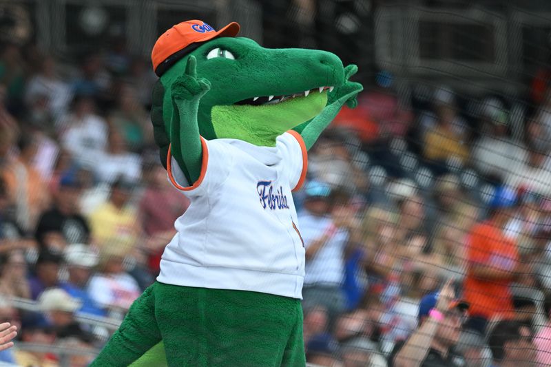 Jun 17, 2024; Omaha, NE, USA; The mascot of the Florida Gators cheers action against the NC State Wolfpack during the ninth inning at Charles Schwab Field Omaha. Mandatory Credit: Steven Branscombe-USA TODAY Sports