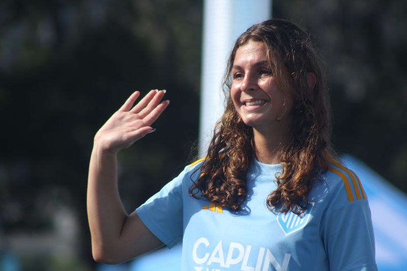 Sporting Jax W-League forward Olivia Bori, a former Bartram Trail High School state soccer champion, waves during the club's uniform release at Friendship Fountain on May 13, 2025. [Clayton Freeman/Florida Times-Union]