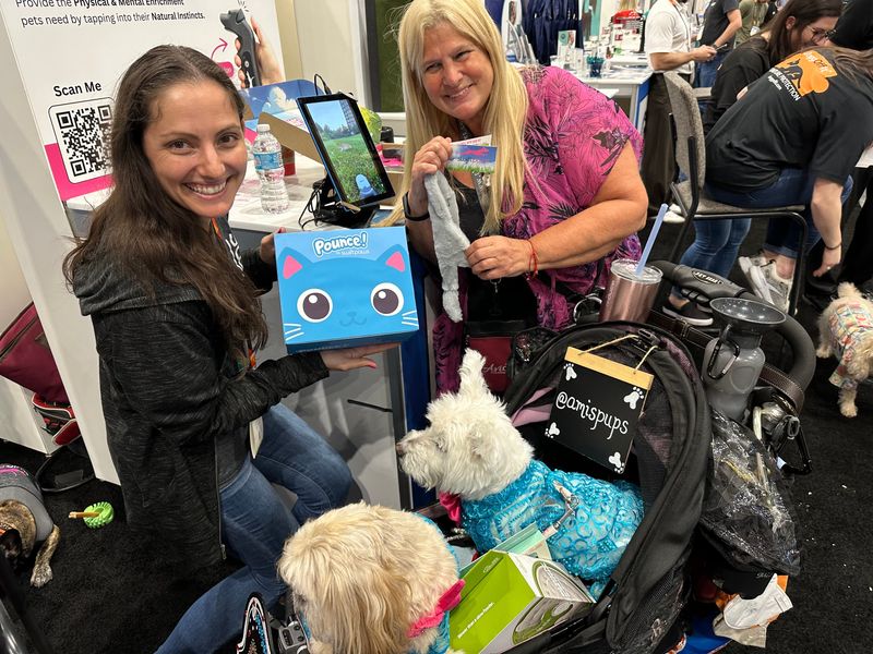 Meghan Wolfgram, left, of Malabar-based SwiftPaws shows off the company's new Pounce lure course for small dogs and cats at Global Pet Expo 2025.