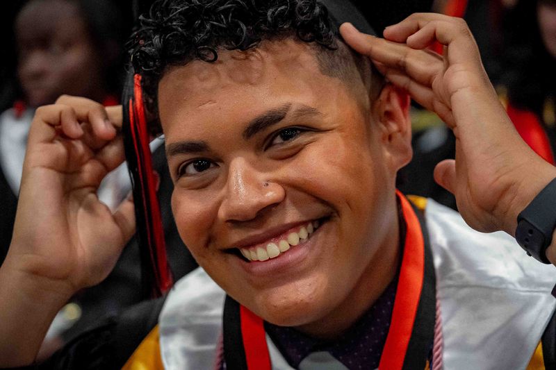 John I. Leonard High School students prepare for graduation ceremonies at the South Florida Fairgrounds and Expo Center in unincorporated Palm Beach County, Fla., on May 14, 2025.