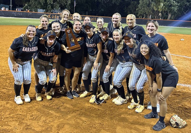 Sarasota High softball coach Heather Mushrush and her players after the Sailors defeated Sumner 8-3 on Thursday night to win the Class 7A-Region 3 championship.