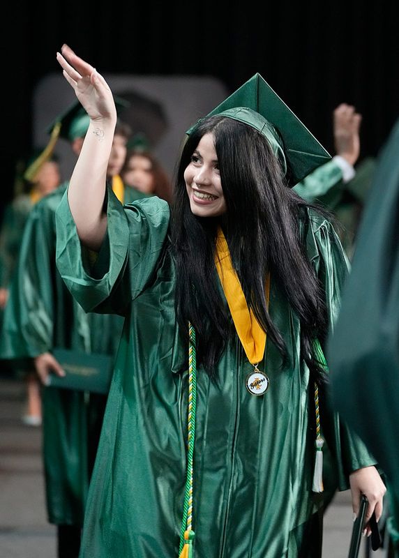 Naomi Pineda waves hello after accepting her diploma. Graduating seniors from the Island Coast High School Class of 2025 celebrated their commencement ceremony May 17, 2025, at Suncoast Credit Union Arena in Fort Myers.