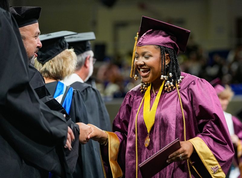 Kaitlyn Correa smiles after receiving her diploma during the Riverdale High School Class of 2025 commencement ceremony at Alico Arena in Fort Myers, Fla., on Saturday, May 17, 2025.