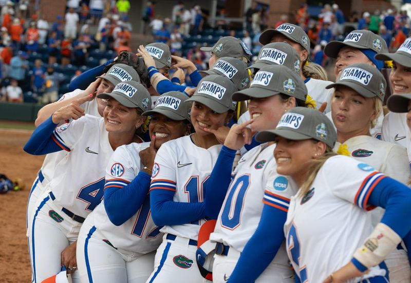 Florida gator pose for photos as they celebrate their 5-2 win over Georgia during the third game of the NCAA super regionals softball game in Gainesville, FL on Sunday, May 25, 2025. Florida goes to the college world series in Oklahoma. [Alan Youngblood/Gainesville Sun]