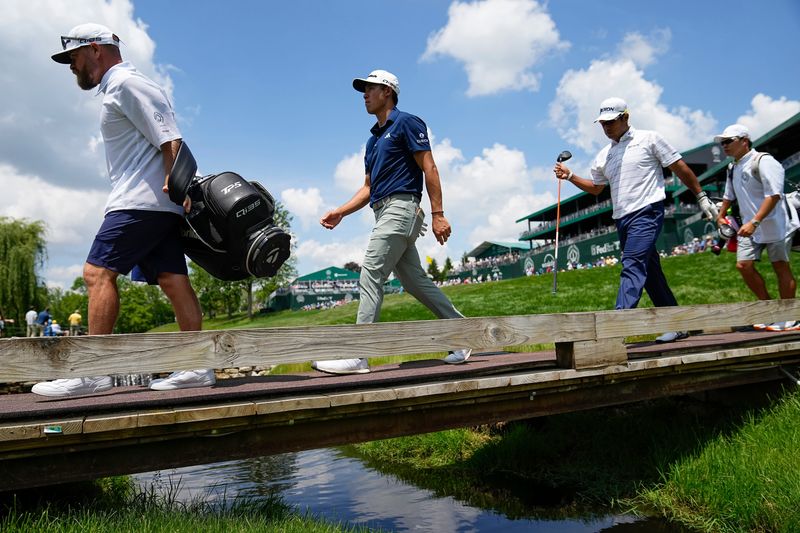 Collin Morikawa and Hideki Matsuyama walk off the 15th tee during the first round of the Memorial Tournament at Muirfield Village Golf Club in Dublin on May 29, 2025.