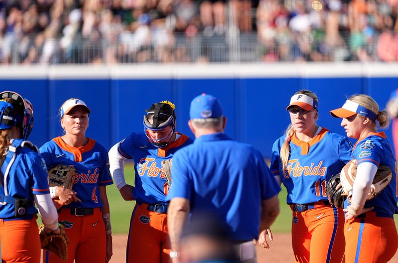 Florida head coach Tim Walton talks with the team during a time out Women's College World Series softball game between the Florida Gators and the Tennessee Volunteers at Devon Park in Oklahoma City, Friday, May, 30, 2025.