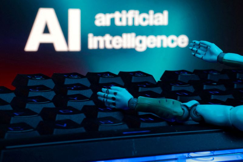 FILE PHOTO: A message reading "AI artificial intelligence", a keyboard, and robot hands are seen in this illustration taken January 27, 2025.