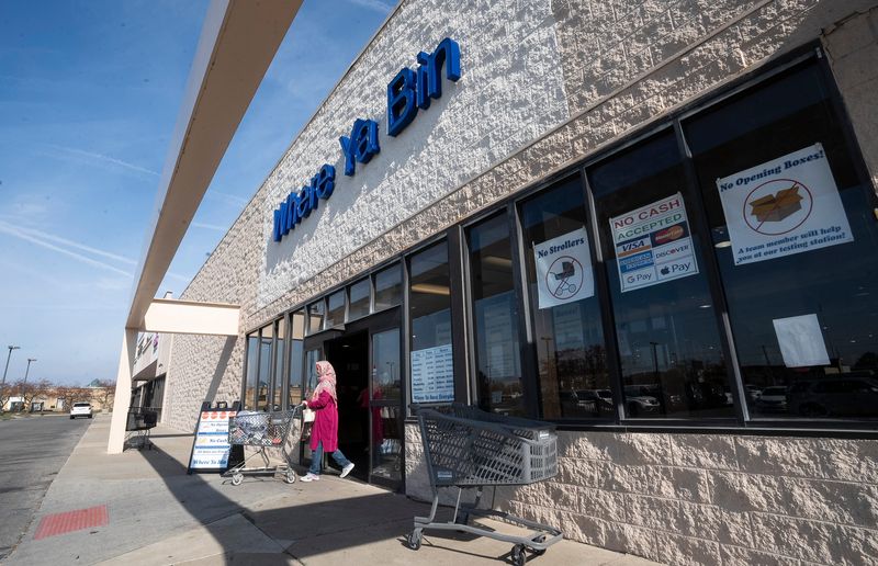 Nov 8, 2023; dublin, ohio, usa; A customer pulls a cart to the parking lot in front of a sign detailing the rules at ÒWhere Ya BinÓ on Sawmill Road. The store offers shopper an opportunity to consider items that are still in their boxes, some of them are return items from Amazon that will not reenter circulation online.